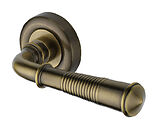 Heritage Brass Reeded Colonial Design Door Handles On Round Rose, Antique Brass - V1936-AT (sold in pairs)