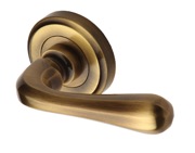 Heritage Brass Charlbury Door Handles On Round Rose,  Antique Brass - V3020-AT (sold in pairs)
