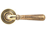 From The Anvil Hammered Newbury Door Handles On Beehive Rose, Aged Brass - 46071 (sold in pairs)