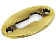 From The Anvil Standard Profile Period Oval Escutcheon, Aged Brass - 83818