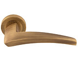 Carlisle Brass Manital Dune Door Handles On Round Rose, Antique Brass - DU5AB (sold in pairs)