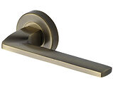 Heritage Brass Metro Angled Design Door Handles On Round Rose, Antique Brass - V3790-AT (sold in pairs)