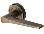 Heritage Brass Gio Door Handles On Round Rose, Antique Brass - V4189-AT (sold in pairs)