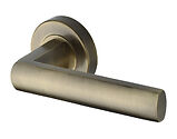 Heritage Brass Poseidon Design Door Handles On Round Rose, Antique Brass - V6230-AT (sold in pairs)